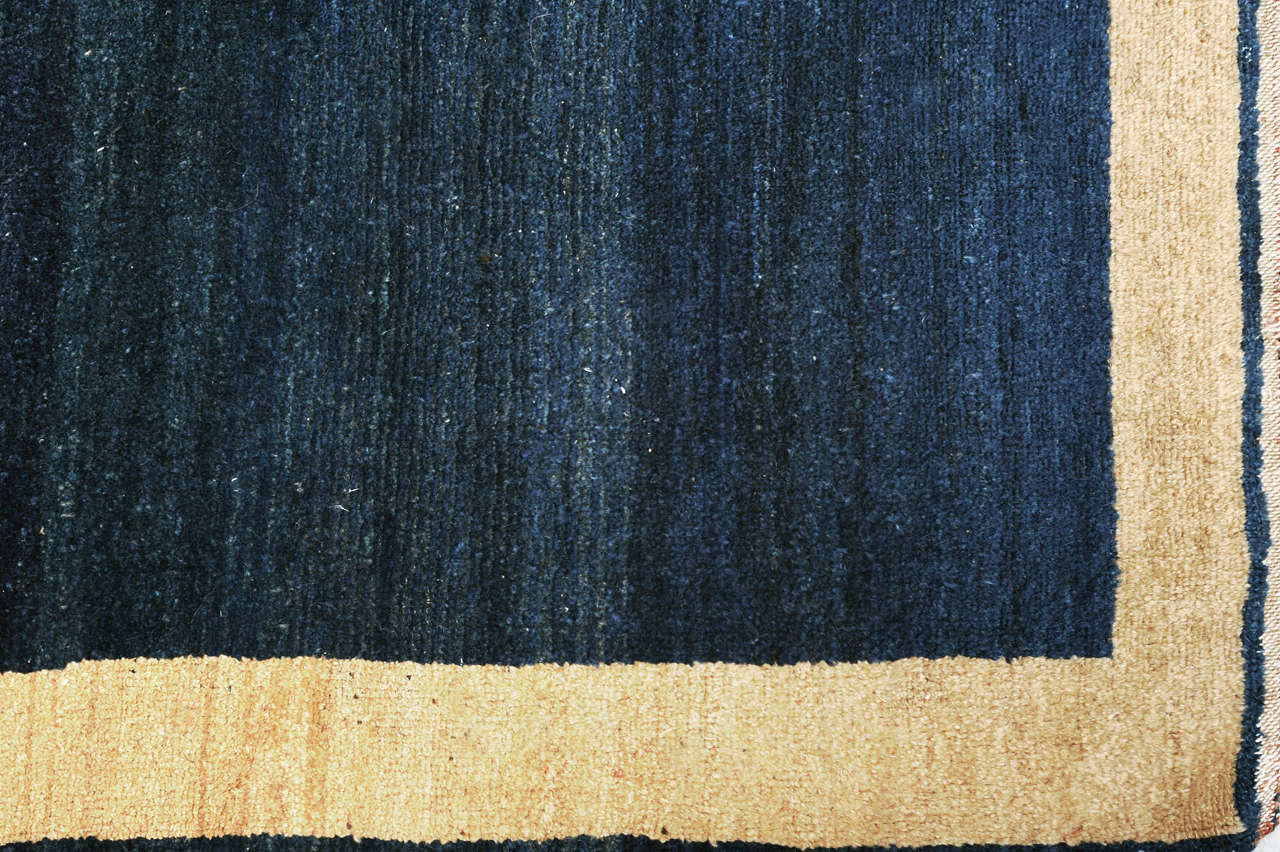 A rare 'minimalist style' Persian long rug, characterized by an open field in various gradations of indigo blue framed by an ivory open field border.
Rugs of this type depart dramatically from the traditional Persian repertoire, which are often
