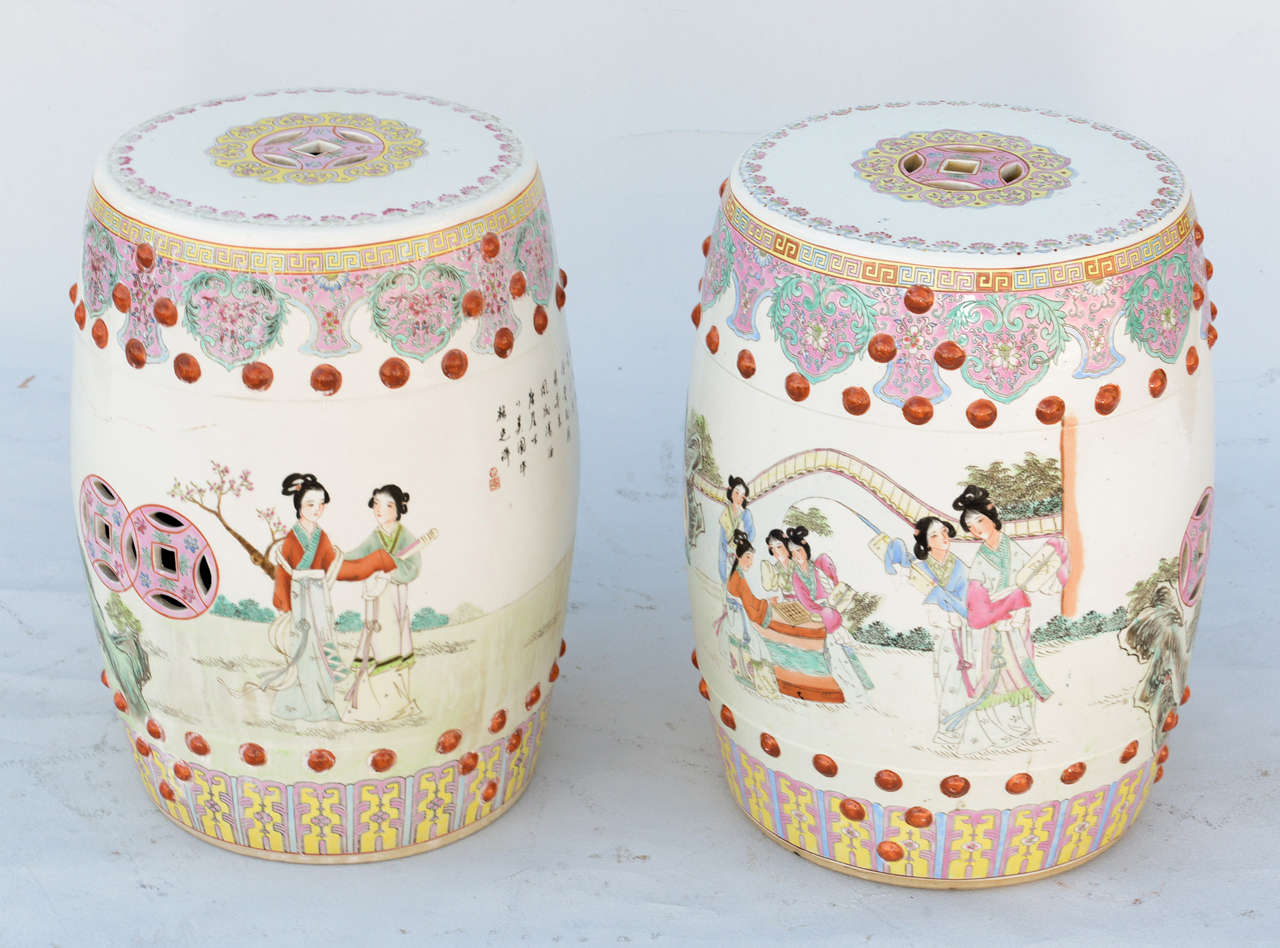 Pair of Famille Rose garden seats, of porcelain, each handpainted with geometric decorations, and raised balls, with Chinese figures depicting court life.