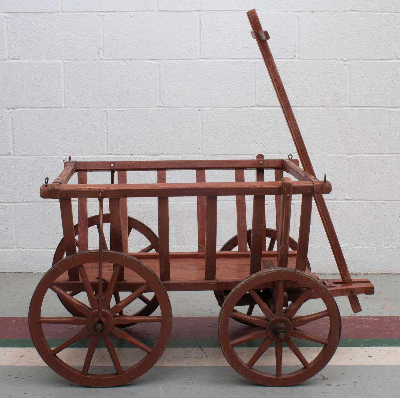 A great goat cart, complete, in excellent working order and entirely original. This piece has many indoor and outdoor decorative or functional uses. In worn original barn red paint.
