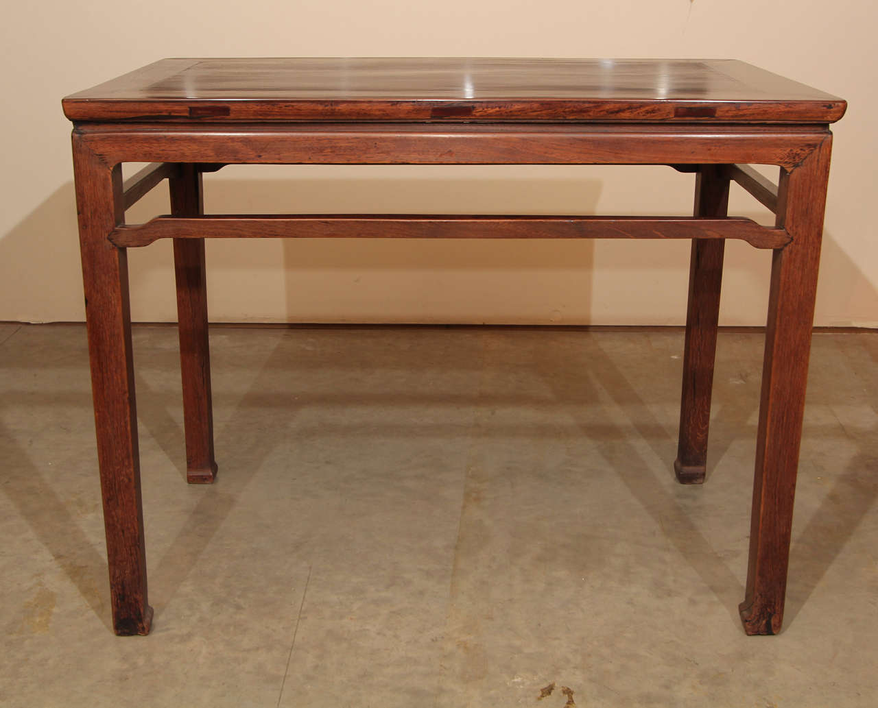 A 19th century Ching dynasty Chinese painting table in the Ming style with blackwood on a Chinese elm base.