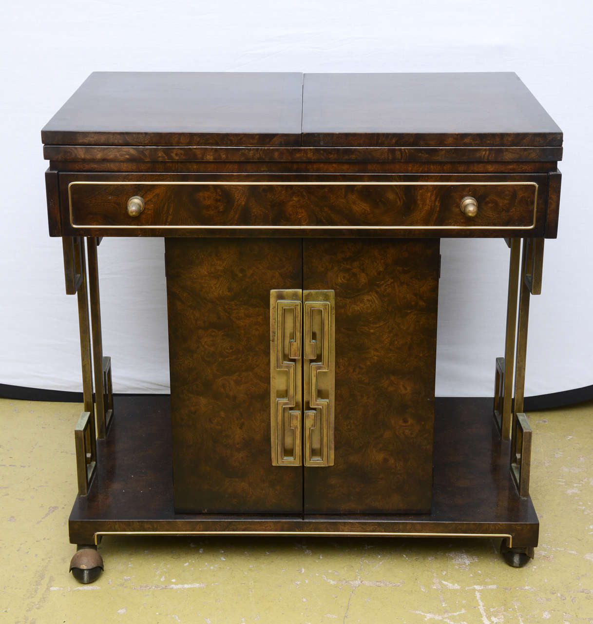 1 drawer teacart with 2 door interior cabinbet, with Brass greek key motif on the sides.  Measures 60