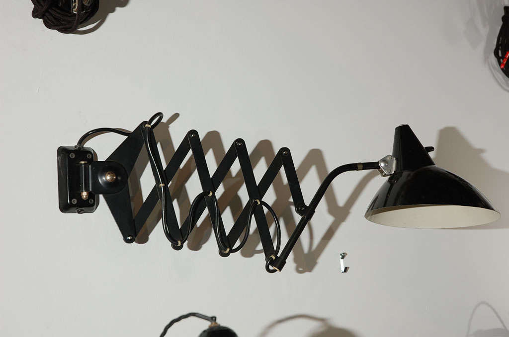 Black painted metal shade and scissor arm wall lamp
