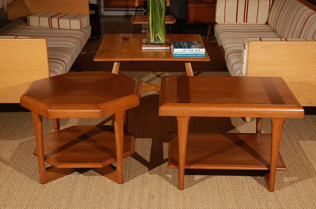 Comprised of solid teak, this heavy unique rectangular side table features an interesting inlay of darker wood running the depth of the piece. In a classic teak hue of golden honey, this side table is absolutely exquisite!