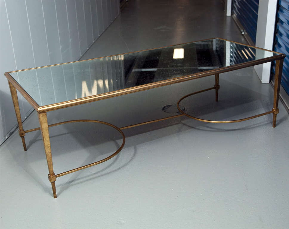 French 1940s style rectangular form low table. Gilt metal frame topped with antiqued mirror.
