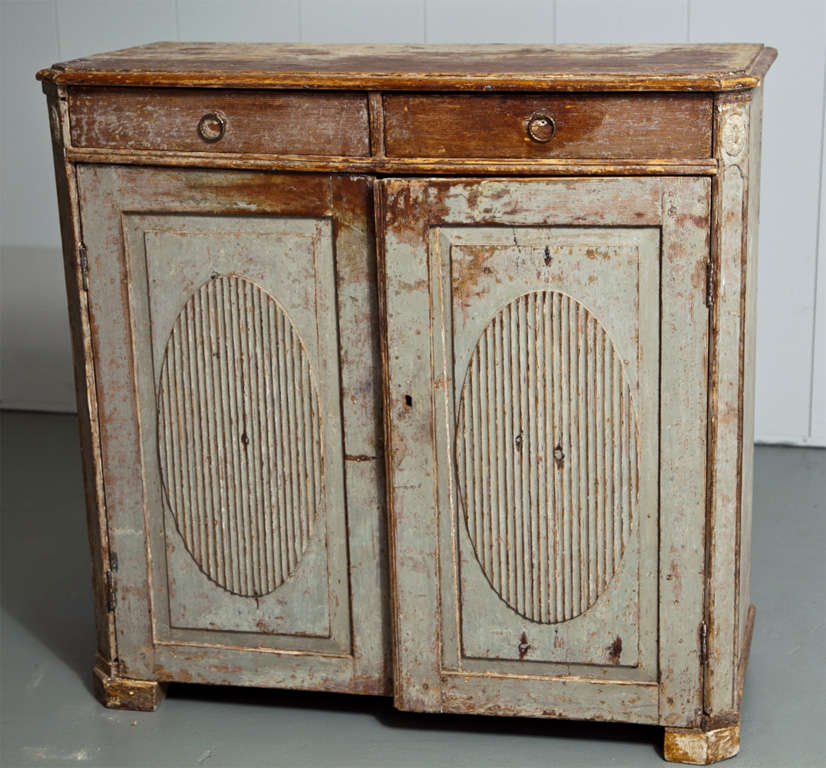 Classic Swedish Gustavian sideboard with lovely pale blue gray original paint. Carved oval designs adorn the front of the doors. Original keys included.