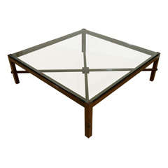 A Robsjohn-Gibbings Square Wooden Coffee Table with a glass Top.