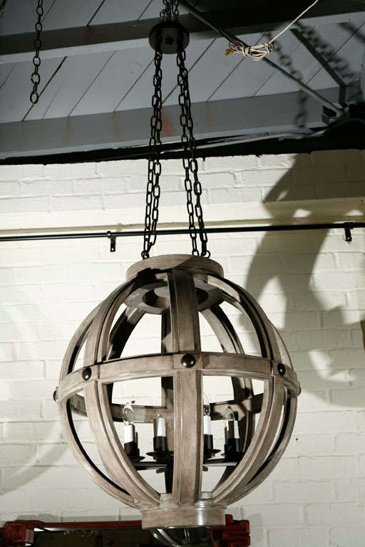 A modern large carved sphere chandelier by Paul Marra shown without reeding and finished in a wash. Available custom. View last image for Bleached Oak version currently in stock.