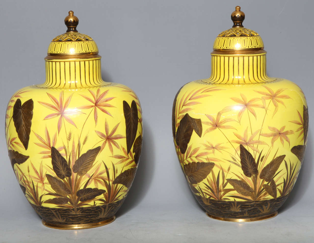 A very unusual pair of antique English Royal Crown Derby porcelain, yellow ground covered potpourri vases, finely painted with multicolored 24-karat gold and enamel. Each finely signed inside the reticulated cover in red.
This color porcelain was