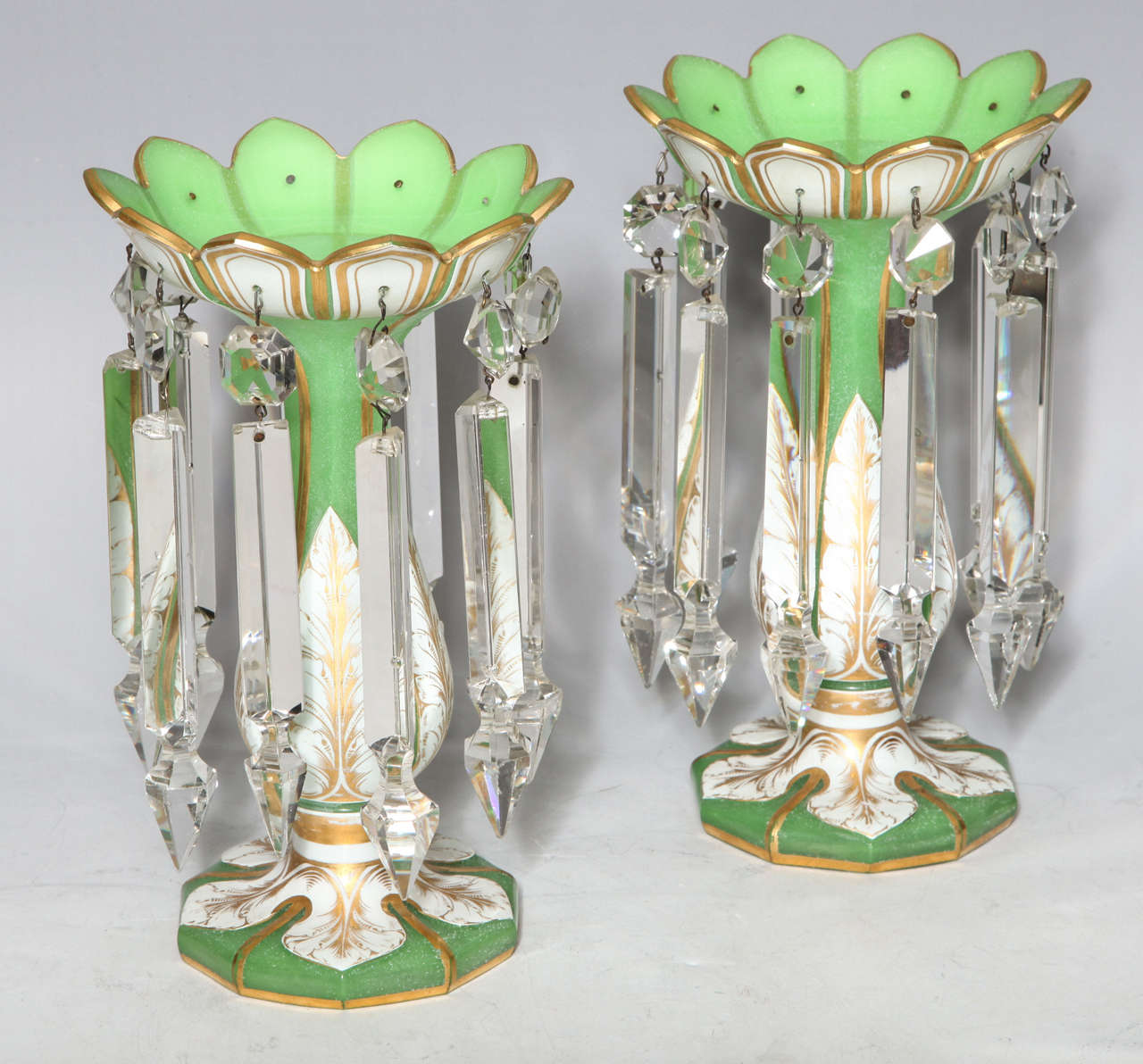 A very fine and quite unusual pair of Antique French double overlay, white over apple green opaline glass cut and faceted Lusters, each further adorned by hand diamond cut crystal prisms. Can be used as candlesticks or flower vases. Small minor