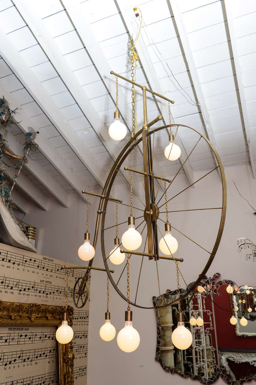 Over the top, one of a kind large brass Penny Farthing bicycle chandelier with ten pendants.