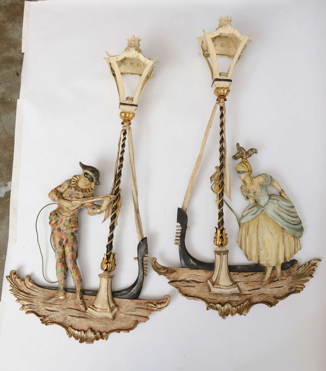 Unusual and whimsical carved Venetian figures in Gondola boats with metal, lighted torches. Hand painted.