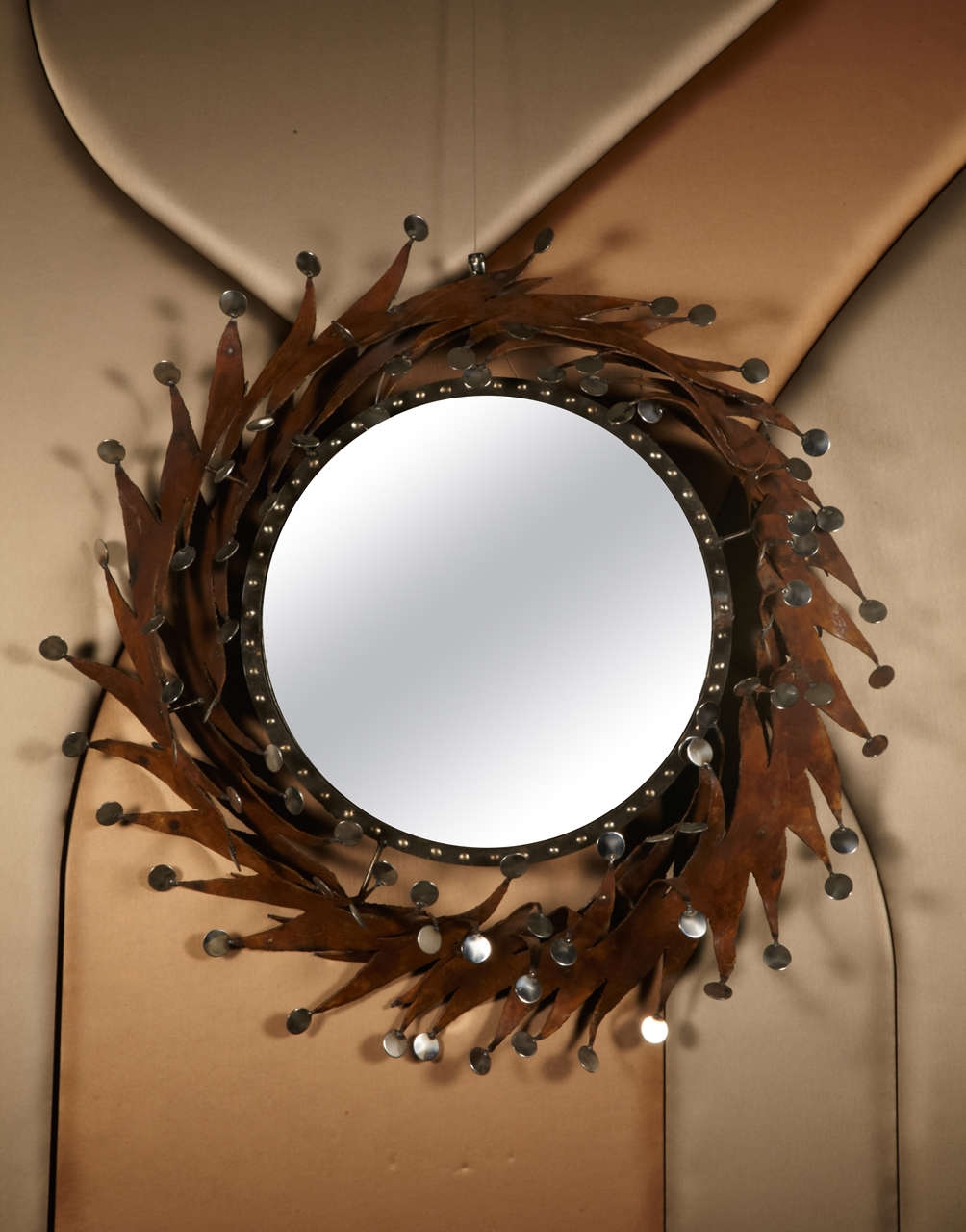 Convex mirror in corten steel with stainless medals.