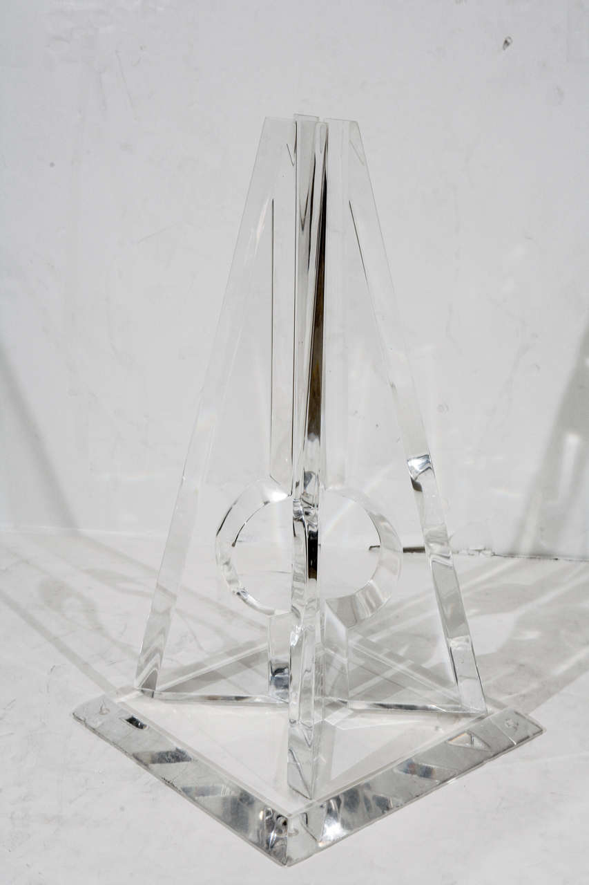 Pyramid sculpture by Hivo Van Teal. Four beveled triangular pieces of Lucite with an open circular center. Signed.