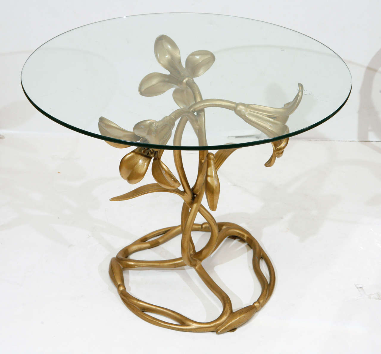Decorative Art Nouveau and gilded aluminum lily side table with glass top by Arthur Court.