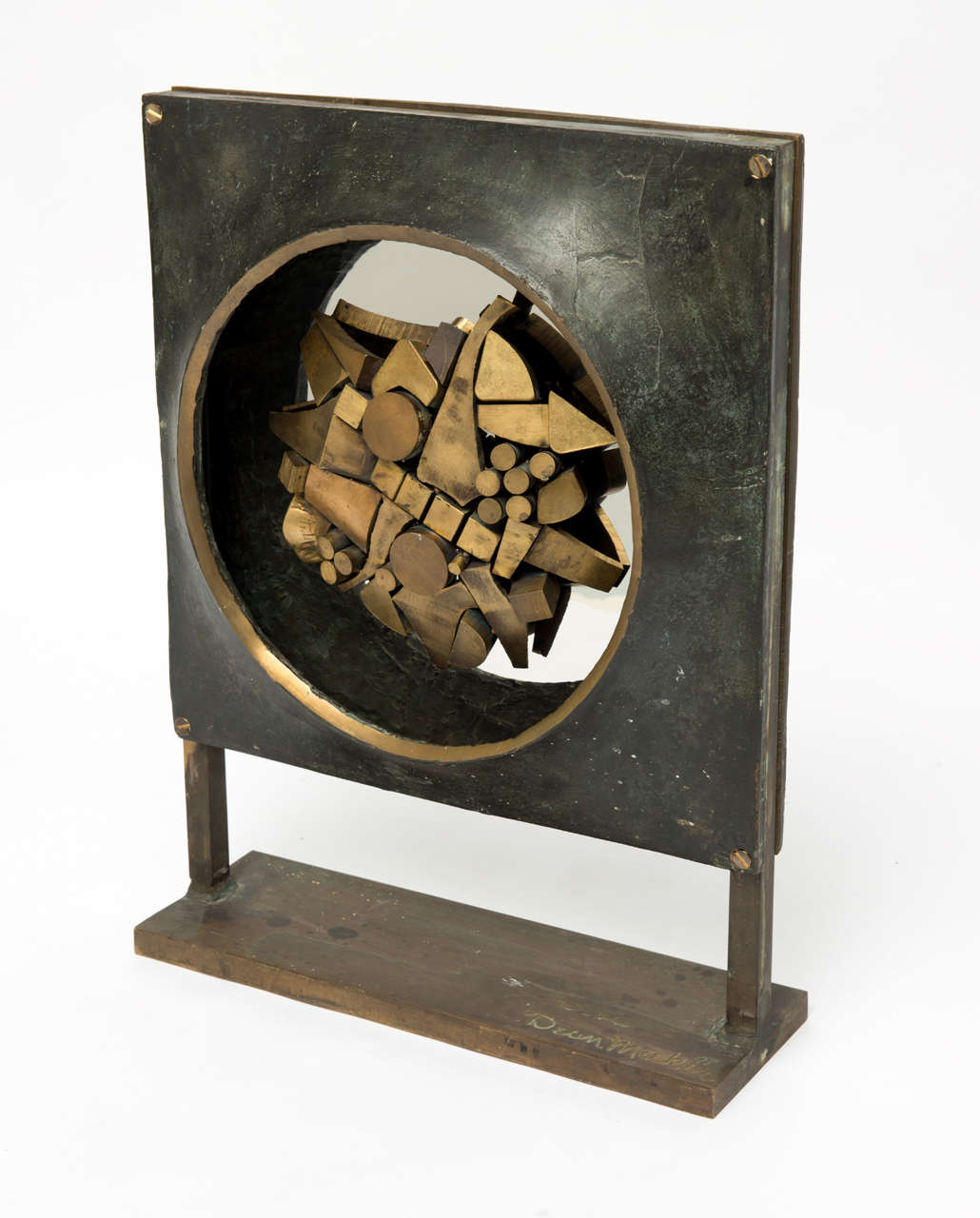 A fantastic unique  Bronze sculpture by Dean Meeker. It  is 2 sided,  one side has the darker surround and brighter center elements and the other side has the lighter surround and the darker center elements. The abstract pattern in the center is