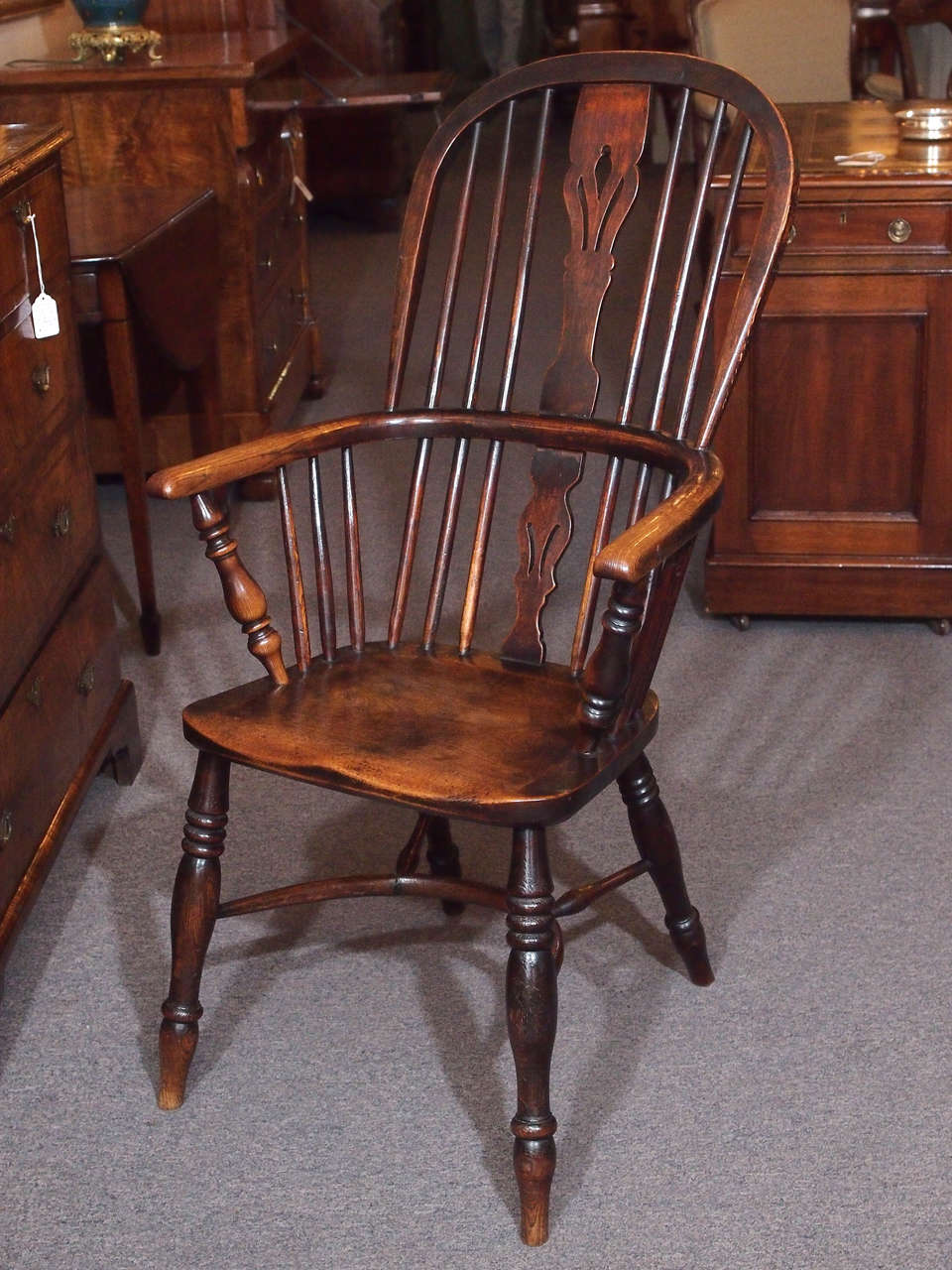 Antique English elm and ash Windsor chair with crinoline stretcher.  Circa 1820.