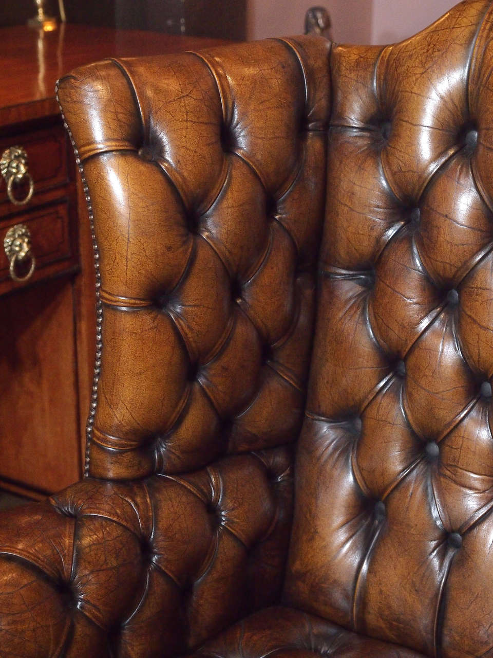 19th Century Antique English brown leather wing chair.