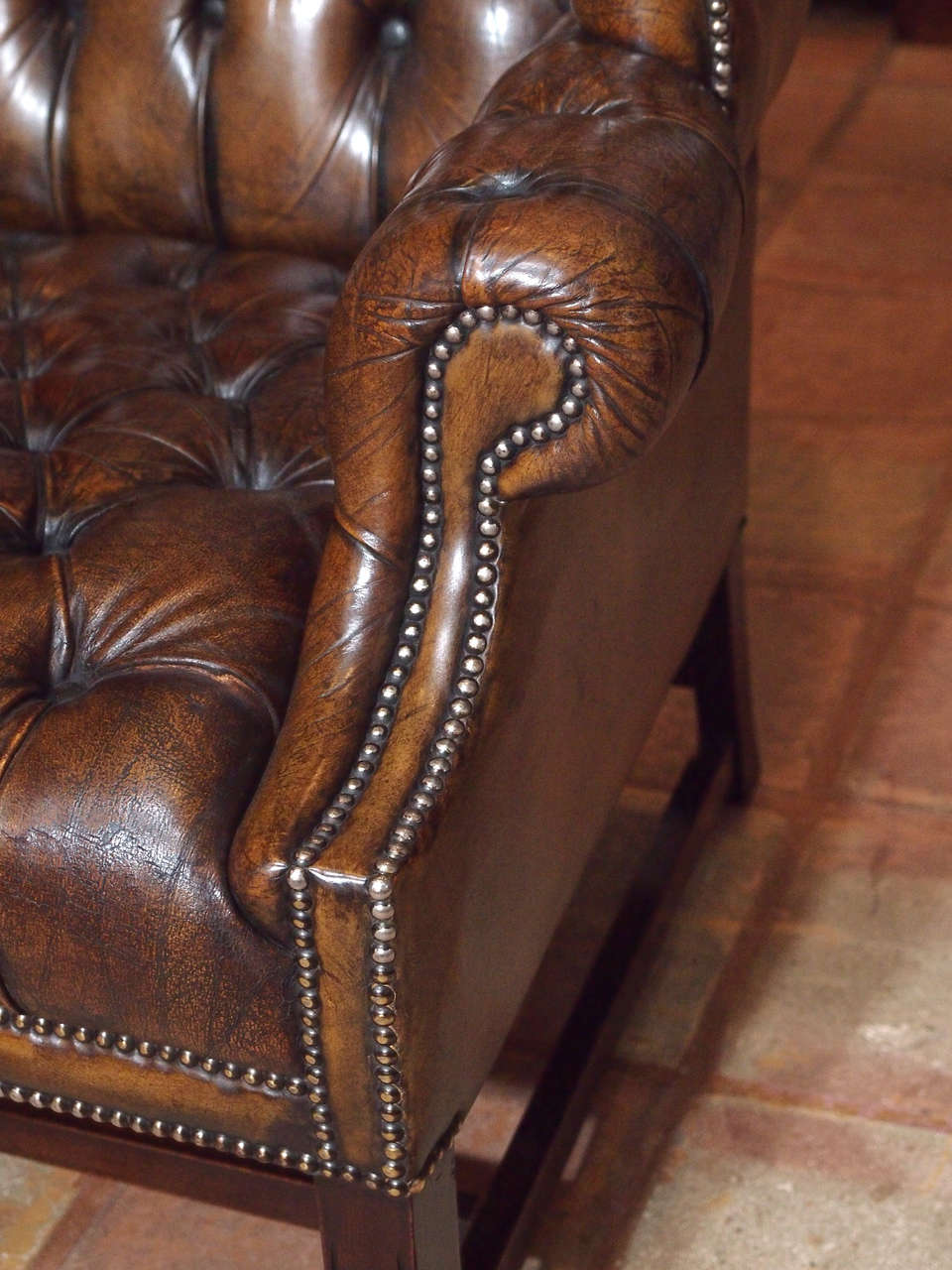 Leather Antique English brown leather wing chair.