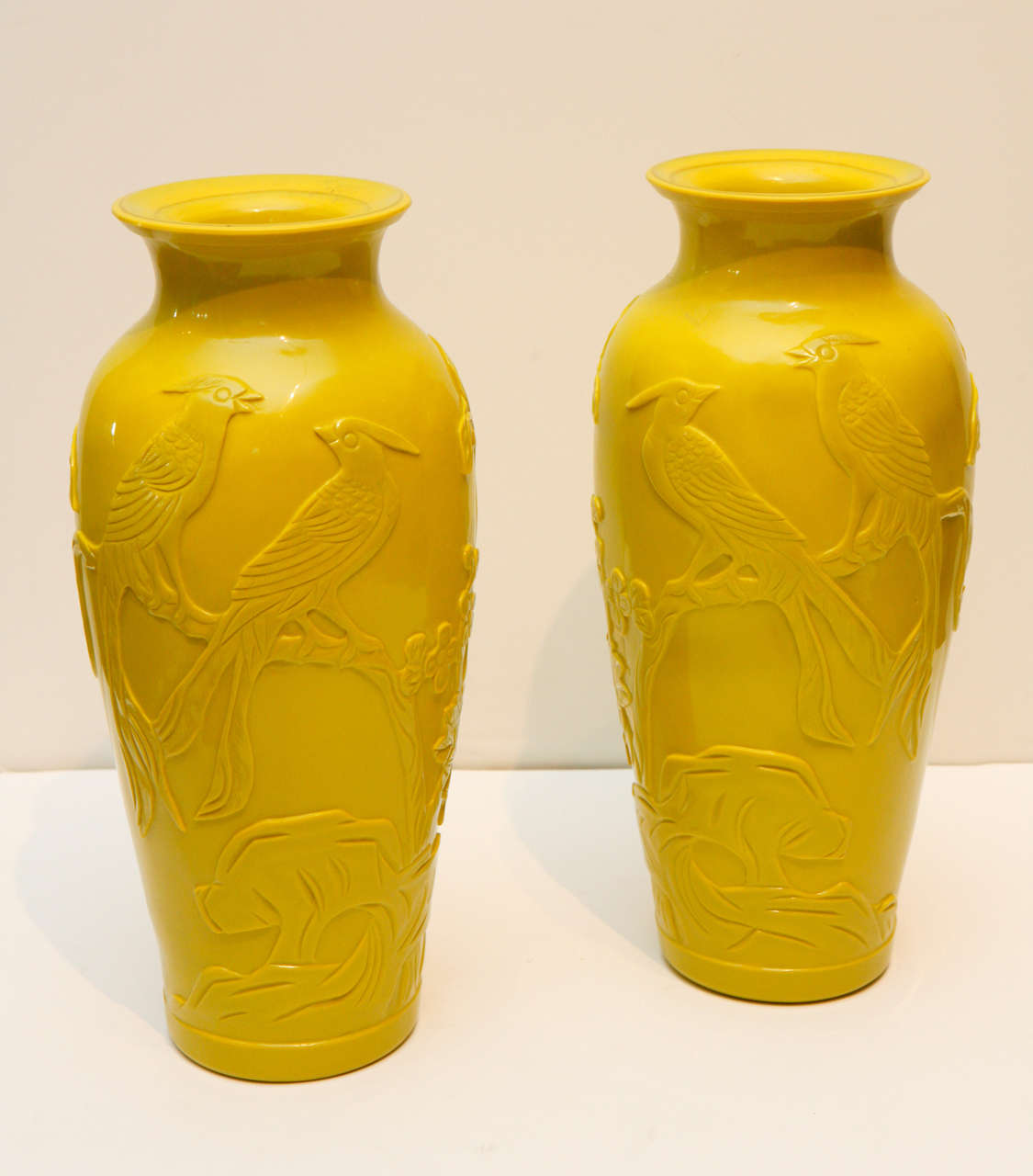 Pair of hand-carved yellow Peking vases with bird motiff.