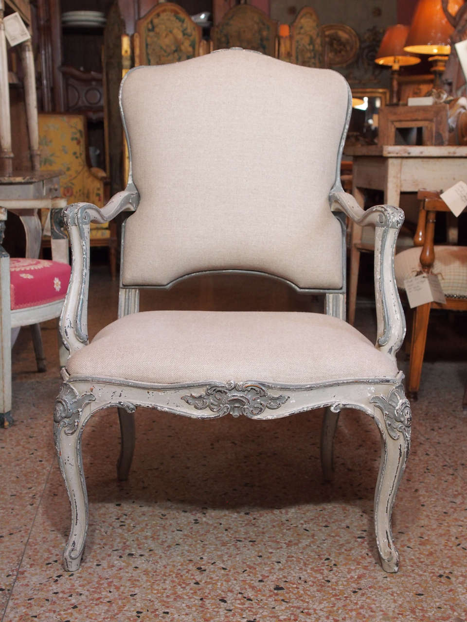 Louis XV style painted and carved armchairs in gray or blue shades.
Shaped and carved apron and cabriole legs.
