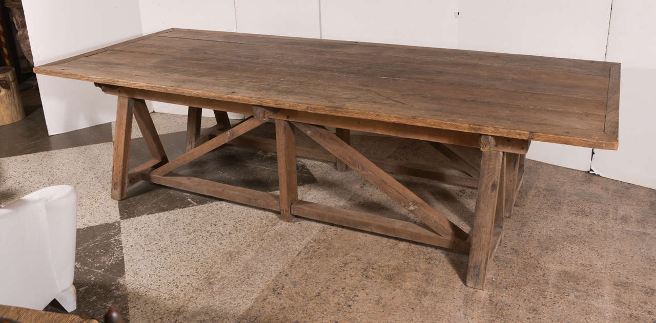 Work table in oak. The base consists of a saw horse on each side in oak. Great patina.