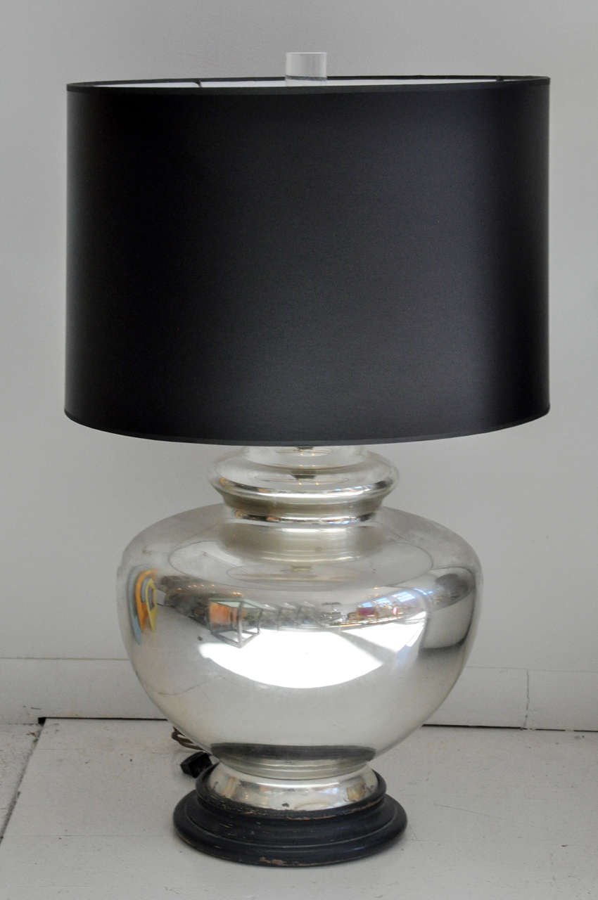 Antique mercury glass urn table lamp recently given a modern makeover with a sleek black drum shade and topped with a lucite finial!.