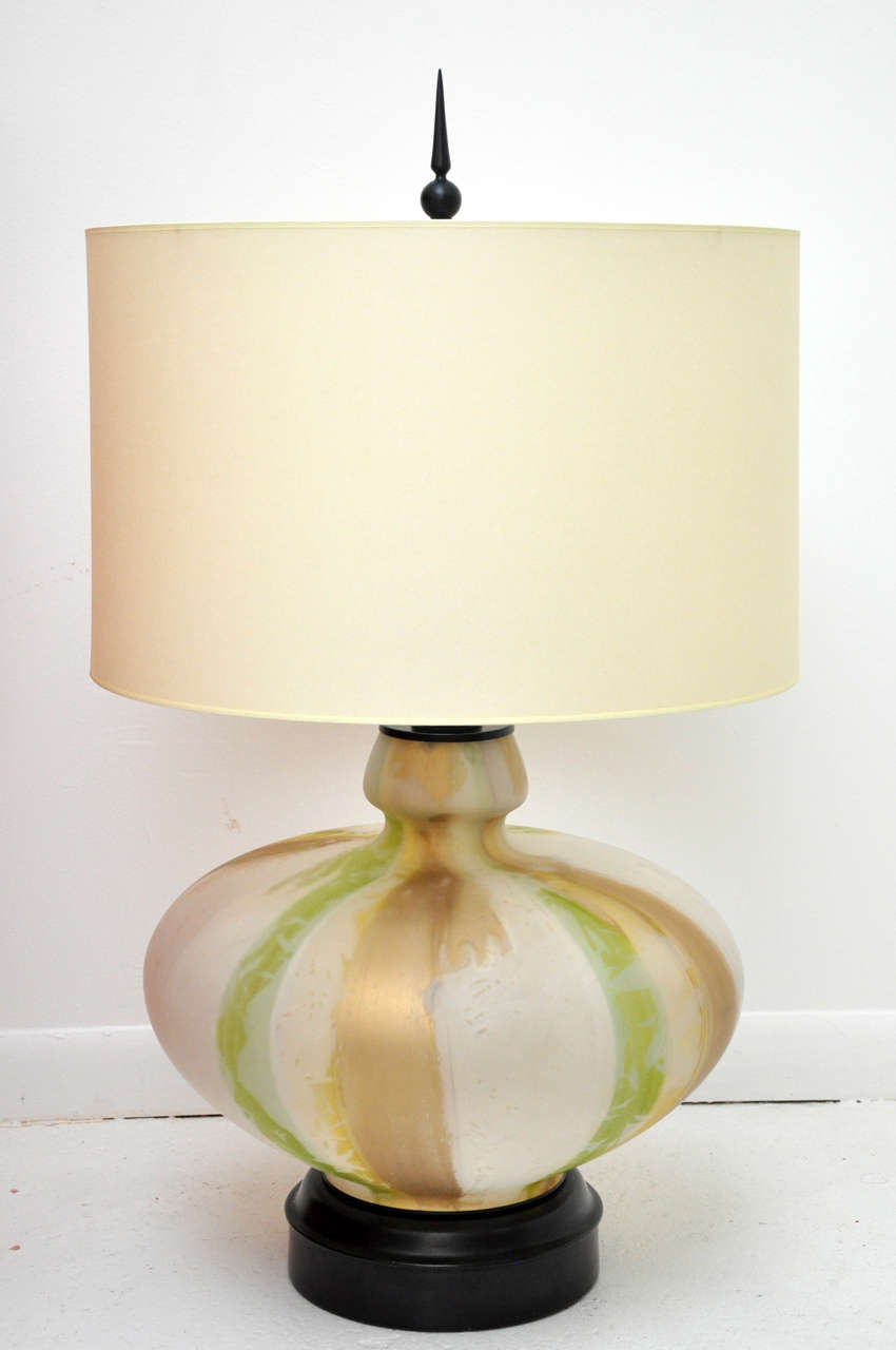 Stunningly gorgeous antique frosted glass interior painted striped lamp in beautiful golden tones. Recently updated with a french paper drum shade. Makes a unique, striking statement with the black base and dramatic finial!

Single Lamp Available.