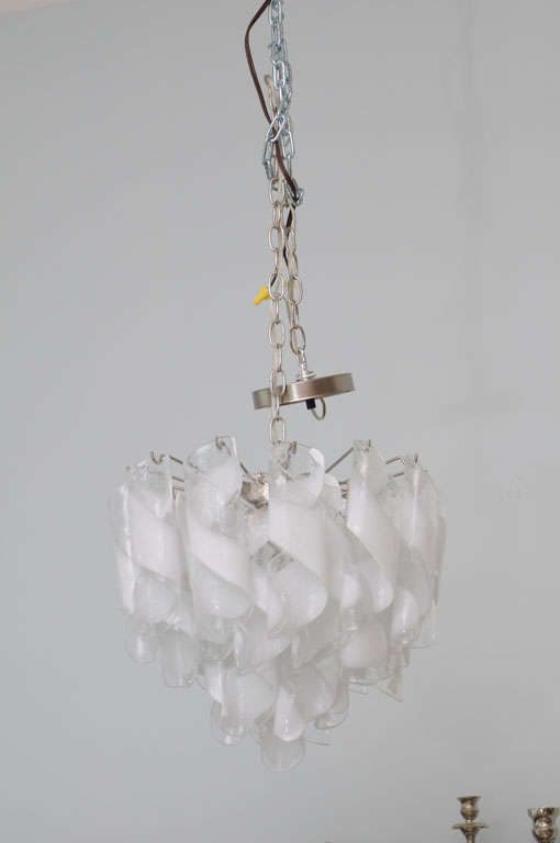 the hand blown glass suspended from a chrome frame