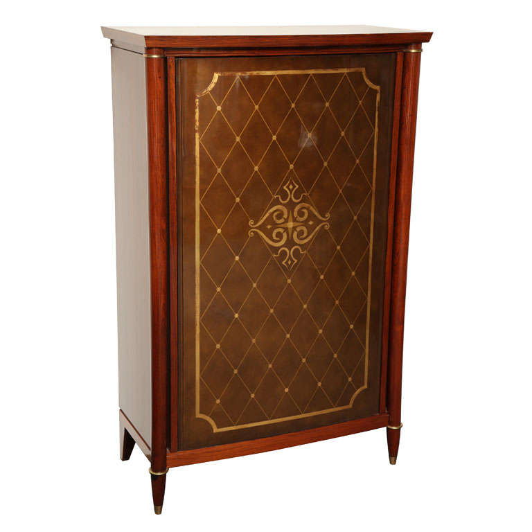 Fine mahogany bar cabinet by Batistin Spade (1891-1969) with its original lacquered and gilt swivel door, and bronze details and sabots.