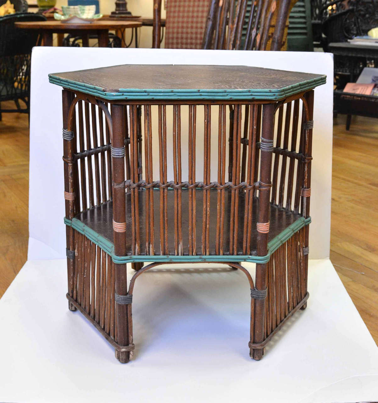 Hexagonal American wicker vintage table from 1920.  Painted in wonderful turquoise trim that is original to the piece.