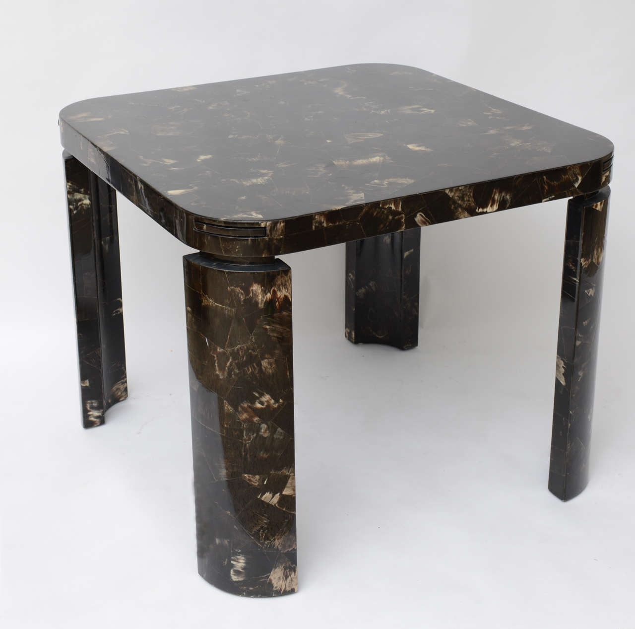 Fashioned from a patchwork of highly-polished horn, this exceptionally well-crafted game table has slide-out drink holders at each corner. A stunning piece.