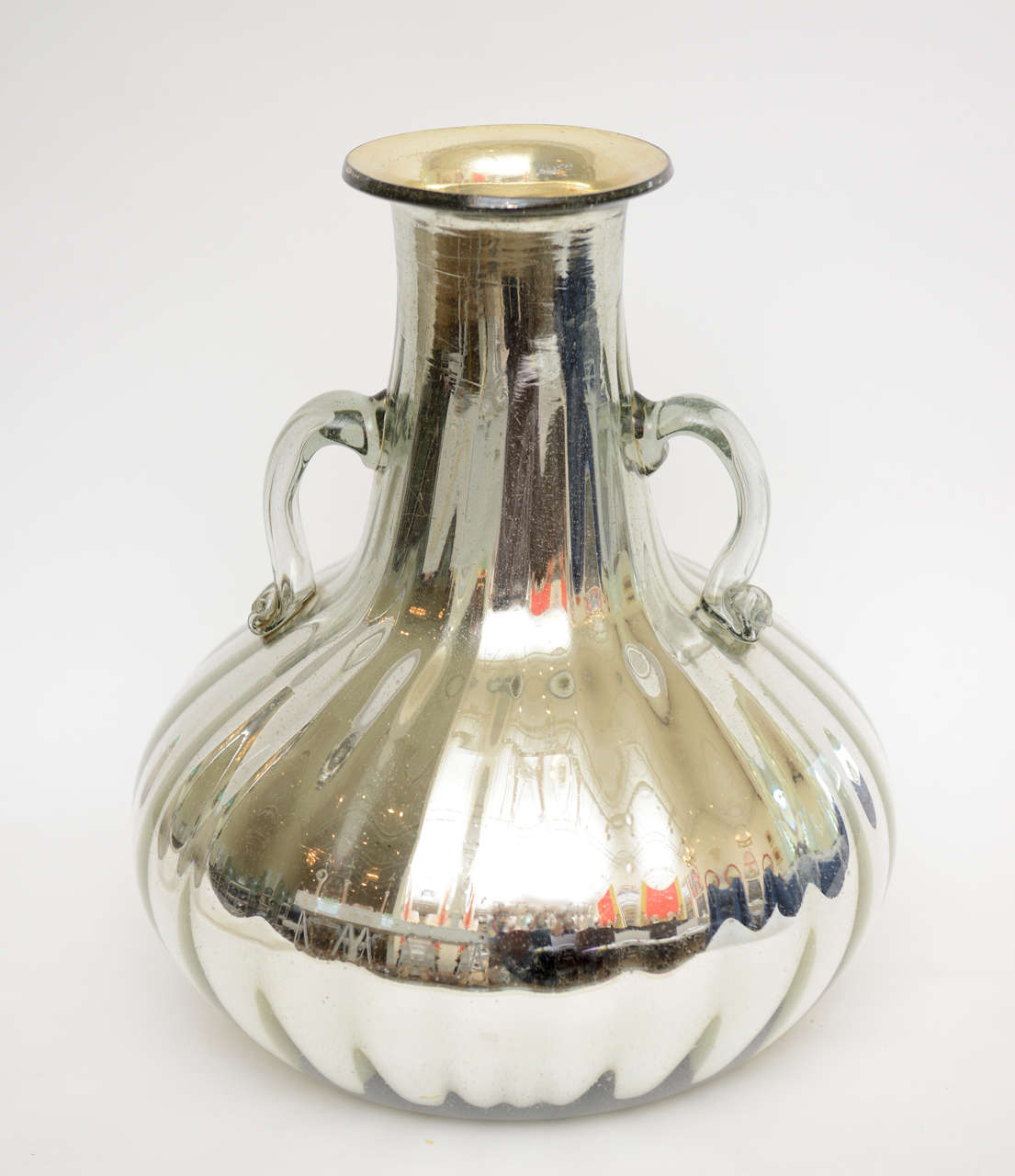 This monumental mercury silver over the top jug/bottle/vase/vessel has clear glass handles. It has a great presence as a great object.
Great object that picks up light  and reflects the room.