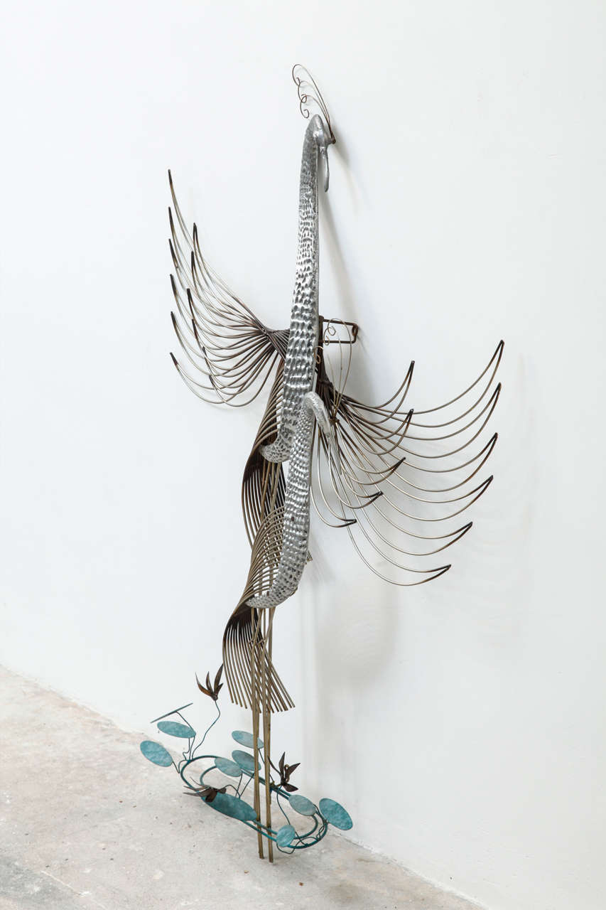Curtis Jere crane birds metal brass wall sculpture.
Patinated brass metal wall sculpture, circa 1970s.
This example has crane birds and flower elements that actually move to the touch. Can be used indoors or out.