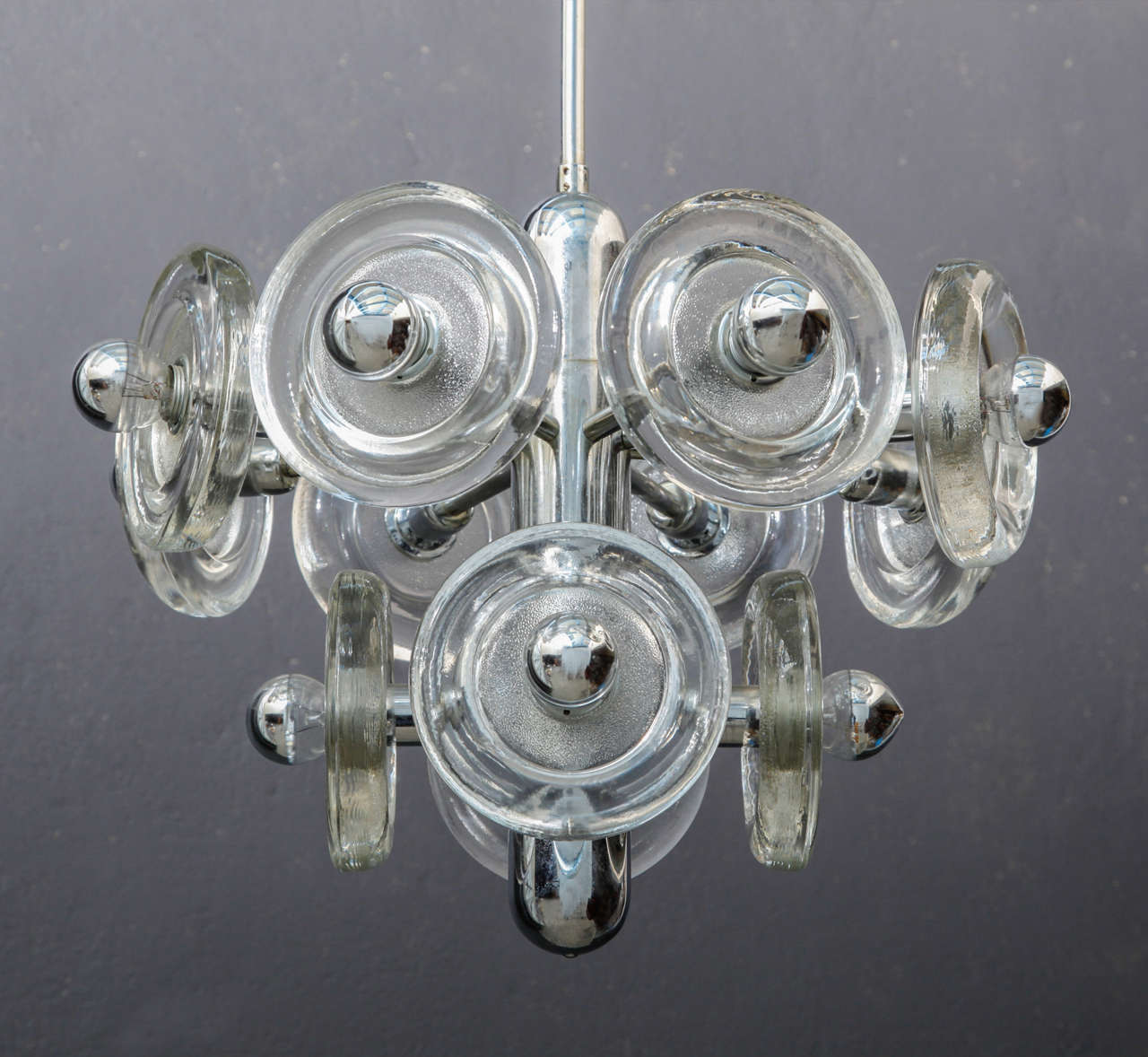 Mid-Century Modern chandelier by Sciolari feature thick clear round ice glass.
Reflective bulbs fixed to a closed fitting, chrome frame.