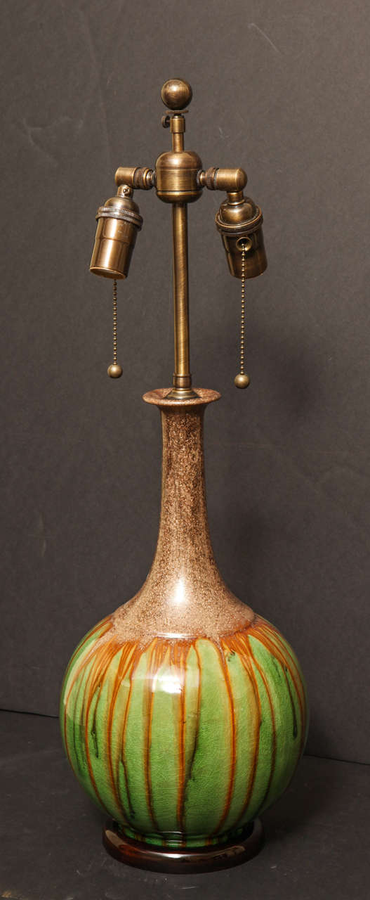 Pair of brown stipple drip glaze over green long neck gourd shaped pottery lamps mounted on lacquered bases.