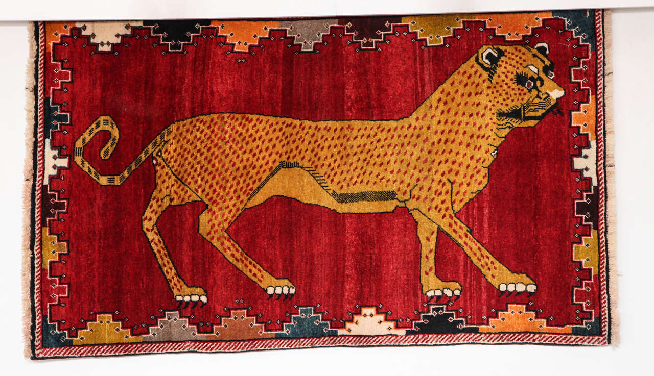 This Persian Qashqai carpet, circa 1940 consists of a wool warp, wool weft and hand-knotted pure wool pile. The vibrant colors were all created using natural vegetable dyes, with beautiful red, orange and gold tones shown throughout the carpet. The