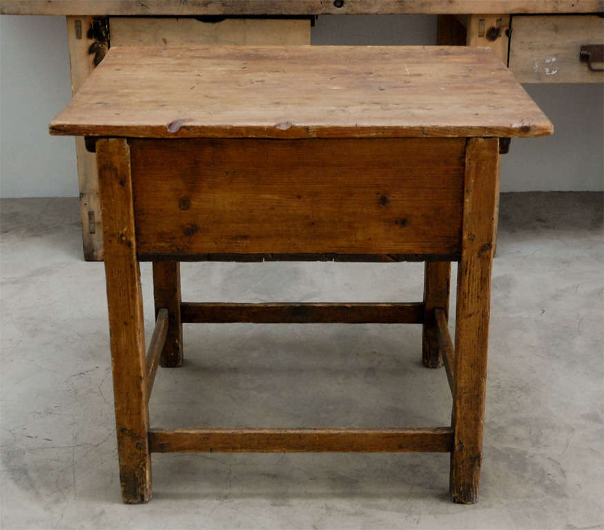 actually it's a bakers table but it's last owner used it as a kitchen island in 
their tight kitchen. the top slides from left to right to expose a perfect storage
space.