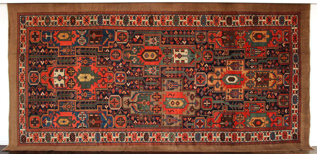 This Persian Meeshan Malayer carpet created, circa 1900 consists of a cotton warp, wool weft, hand-knotted wool pile and organic vegetable dyes. Its vivid greens, blues and reds are beautifully balanced and set off by a unique undyed camel wool