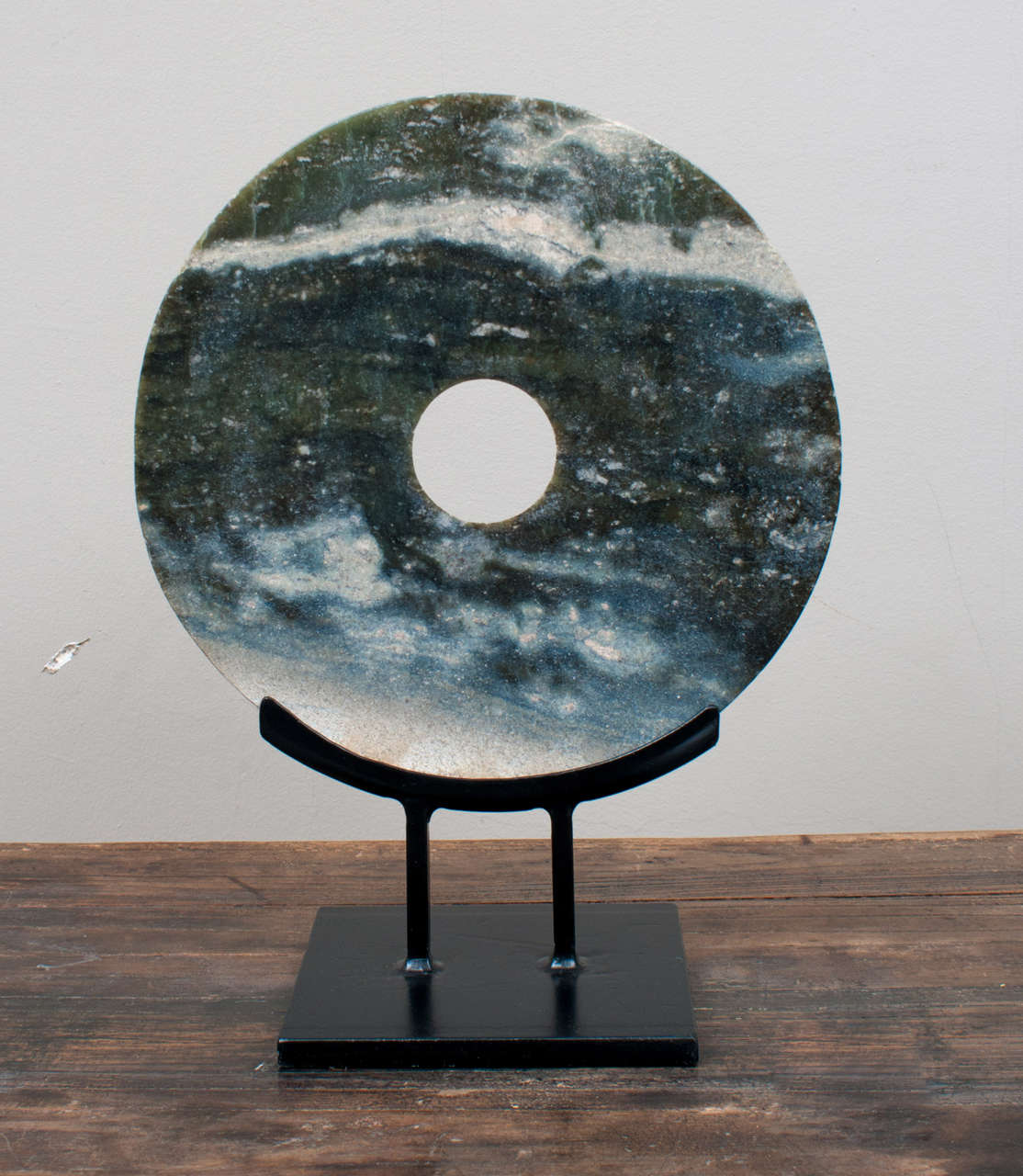 The Bi Disc is an ancient artifact in the form of a circular flat jade disc. The earliest discs were excavated from burial grounds in China. Traditionally the Bi was associated with Heaven, and was perhaps, the first religious symbols. In modern