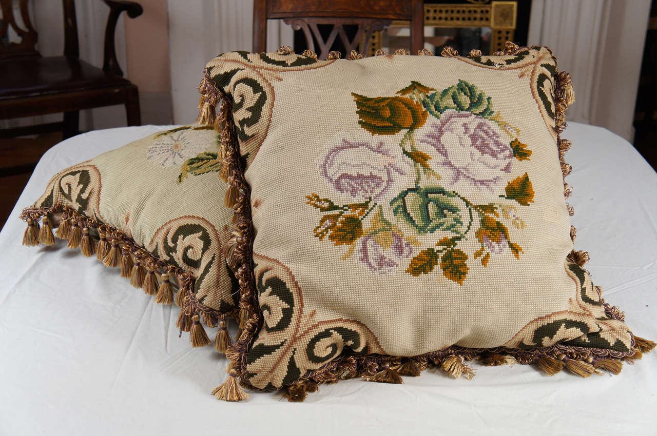 Pair of 19th century continental floral needlepoint pillows with elaborate fringe and plaid taffeta reverse sides, 20th century.
Upholstery.