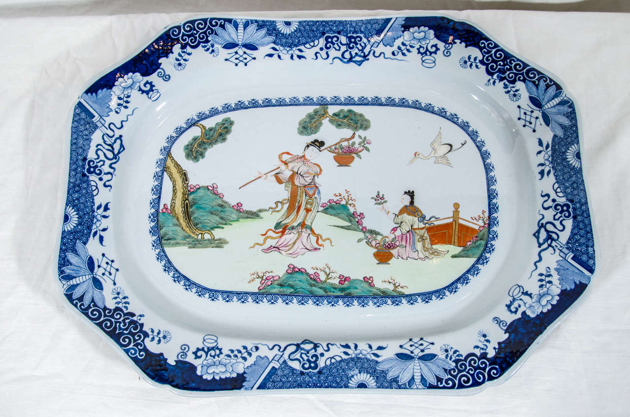 A Spode platter showing a scene of two young women with flowers in a garden. The scene is filled with traditional Chinese symbols of happiness.
The crane flying above and the pine tree symbolize both status and longevity. Coupled with spring