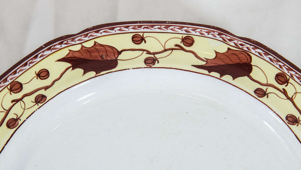 A set of ten early 19th century creamware dishes with a beautiful border decorated with brown oak leaves and acorns painted on a soft yellow ground.
 Patterns like these date from the last quarter of the eighteenth century into the first quarter of