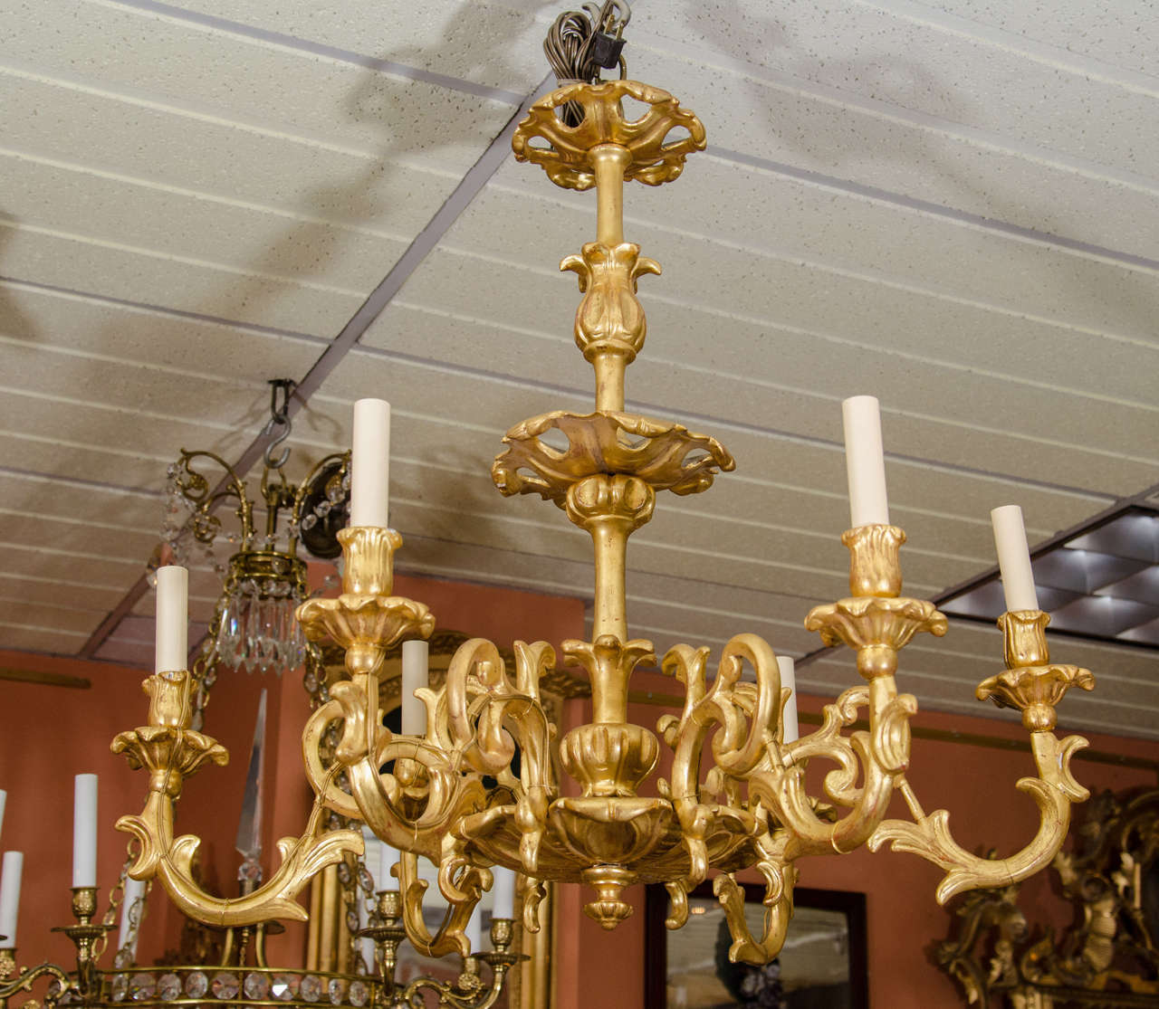 Italian Rococo giltwood six-light chandelier with scrolled arms and turned and carved foliate motif shaft.