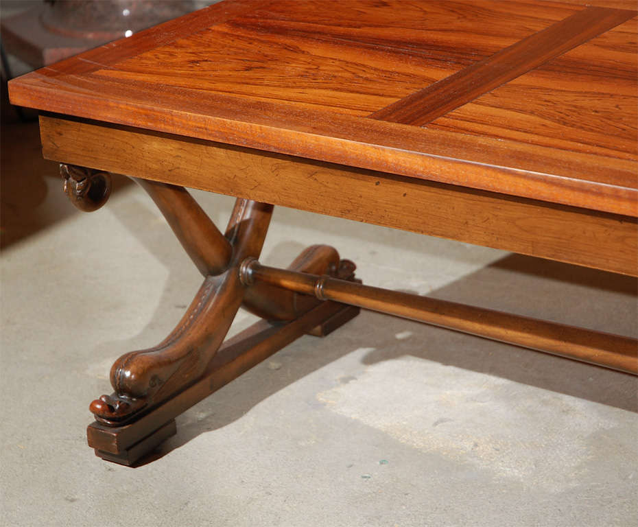 Rosewood or walnut lounge coffee table with serpent legs and baker tag.