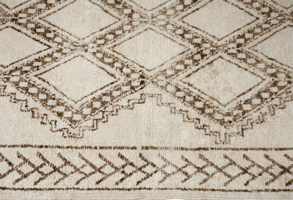 White Moroccan rug with graphic light brown pattern.