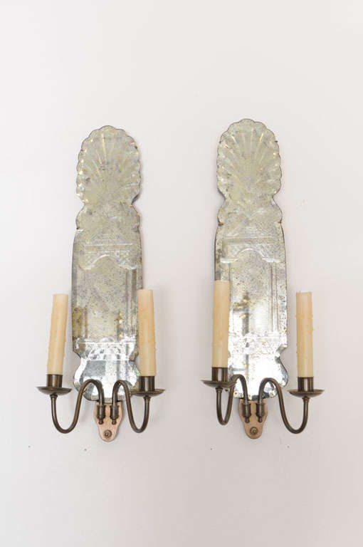 Glamorous pair of  Venetian etched mirrored electrified sconces with bronze arms and wood backing.