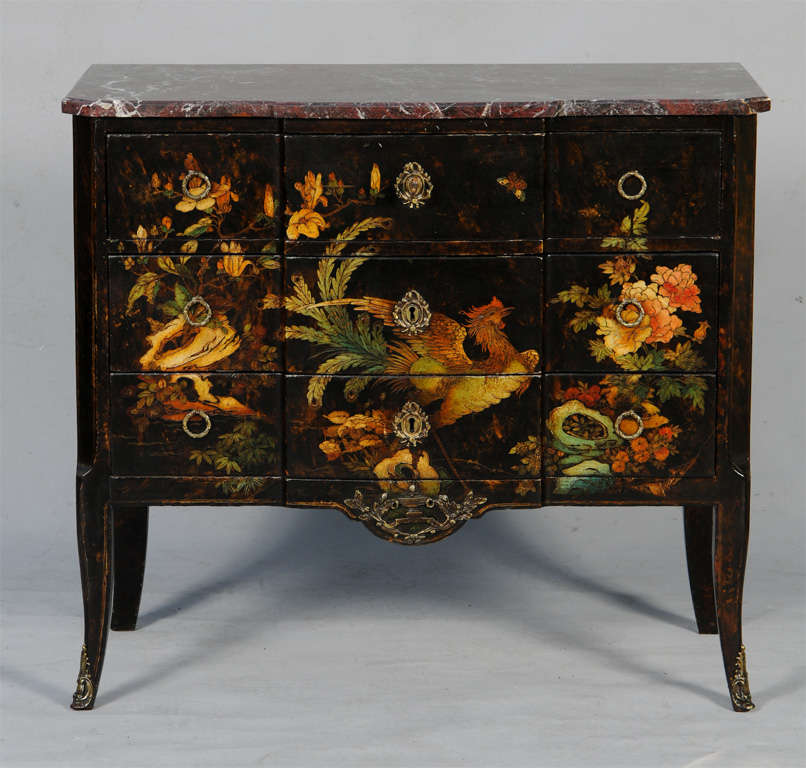 Commode, having a rust-colored top of marble, on black lacquered case of three stacked drawers, over  japanned decoration of rooster and florals, brass escutcheons, pulls and classical urn ormolu, raised on splayed legs with sabots.