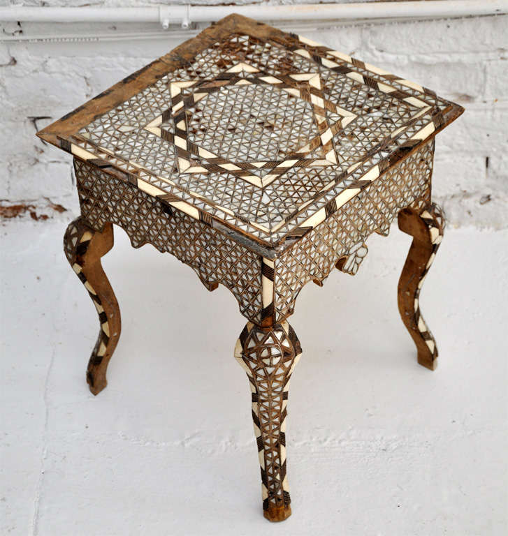 Vintage Moroccan wood side table with inlaid horn and mother of pearl mosaic tiles.  One drawer at front of table.