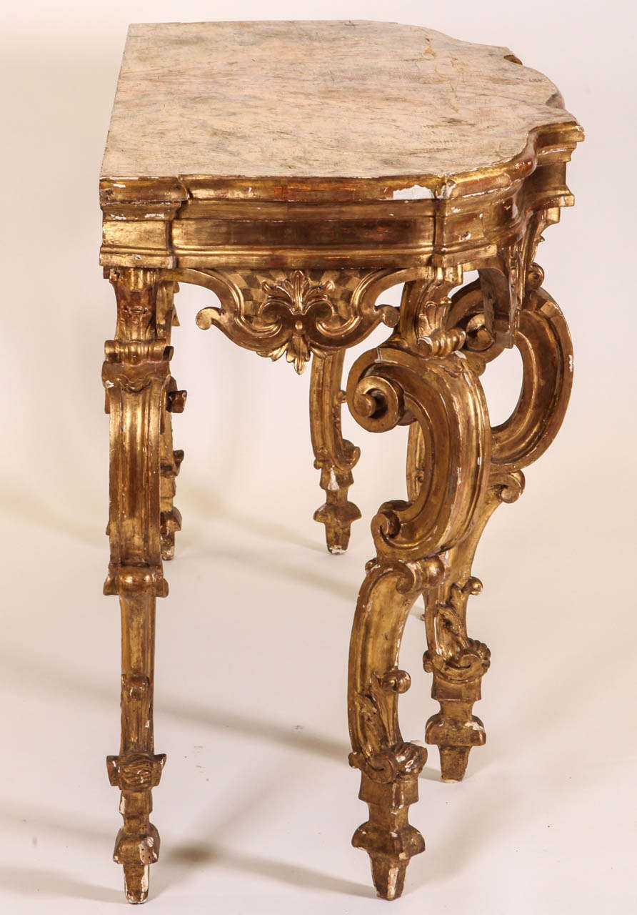 A fine Nord Italian 18' century  Carved and Gilt-wood  Consol Table  with  a Painted  Faux  Marble Top. 
cm 175 x65x 93