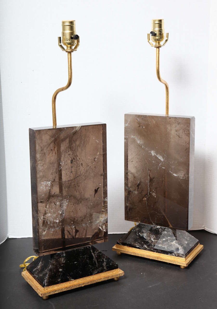 Unusual pair of Deco style rock crystal quartz table lamps on gilt metal rectangular bases.
Stock Number: MD18.
